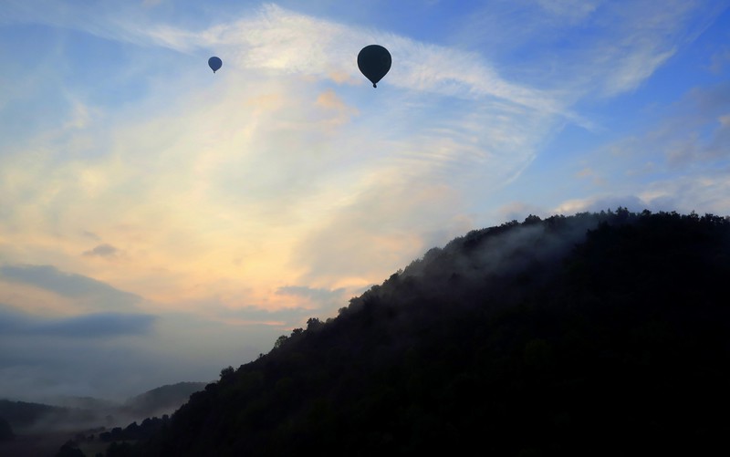 Silhouette shots of hot air balloons taken from our basket 
